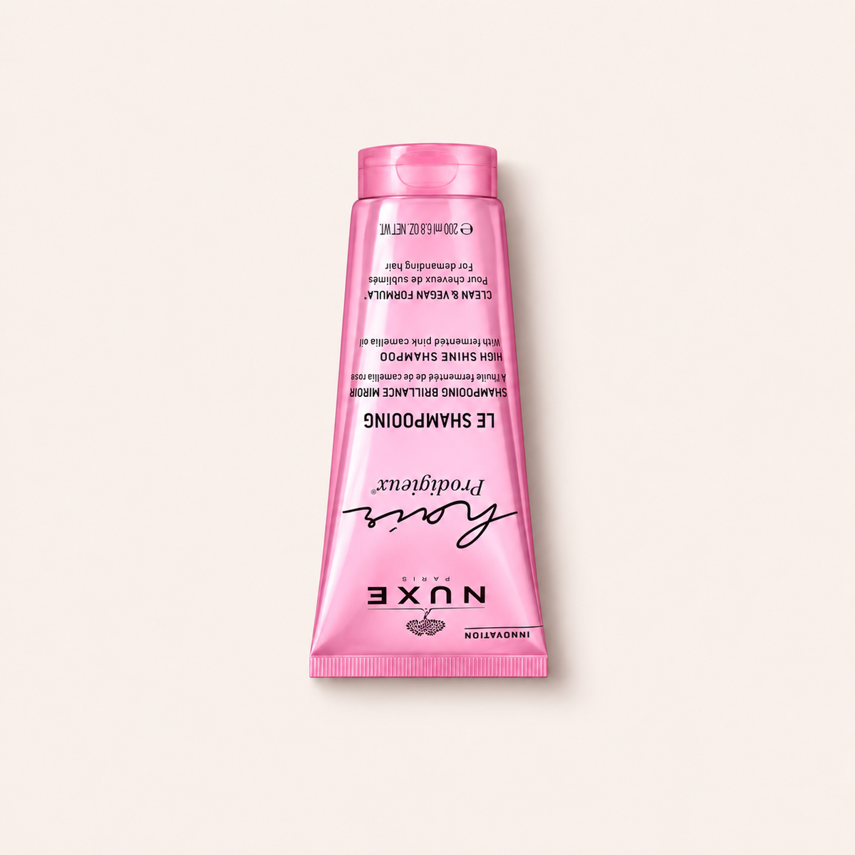 NUXE Hair Prodigieux High Shine Shampoo 200 ml – produkt ležící na zádech, pohled shora